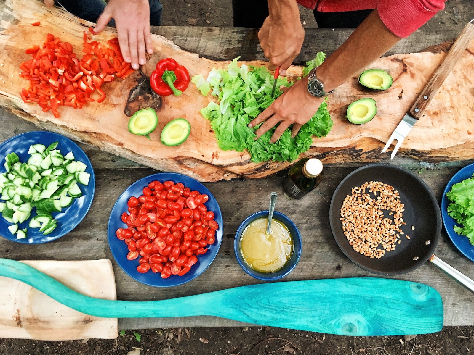 Hands of two people cooking vegetables together