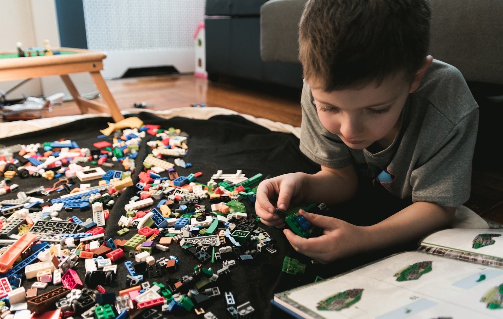 Young boy playing with Legos on the floor