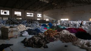 mountains of textile waste in a warehouse
