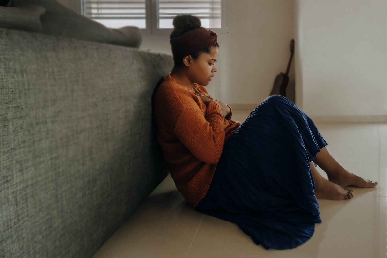 Anxious girl sitting on a floor