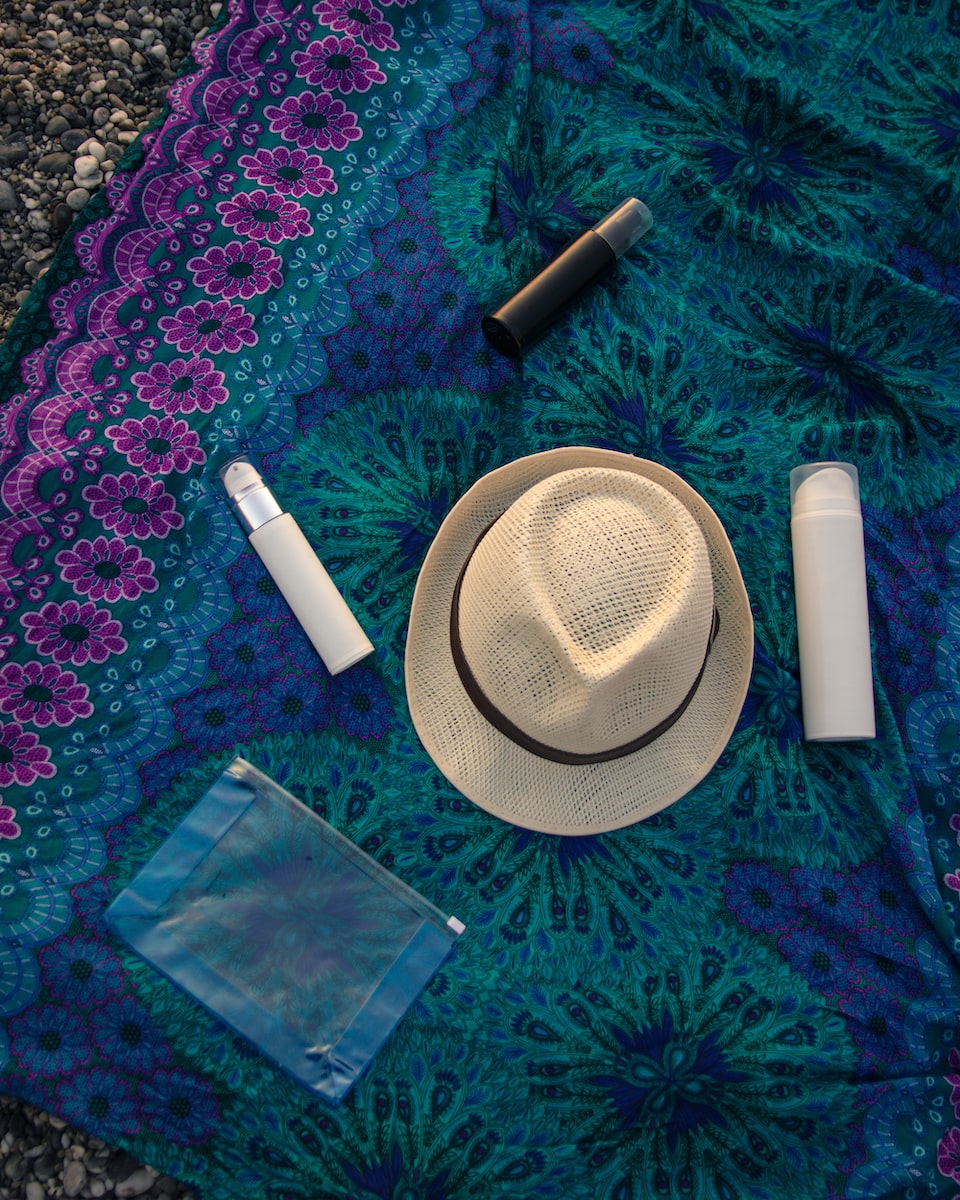 Hat and sunscreen on a blanket