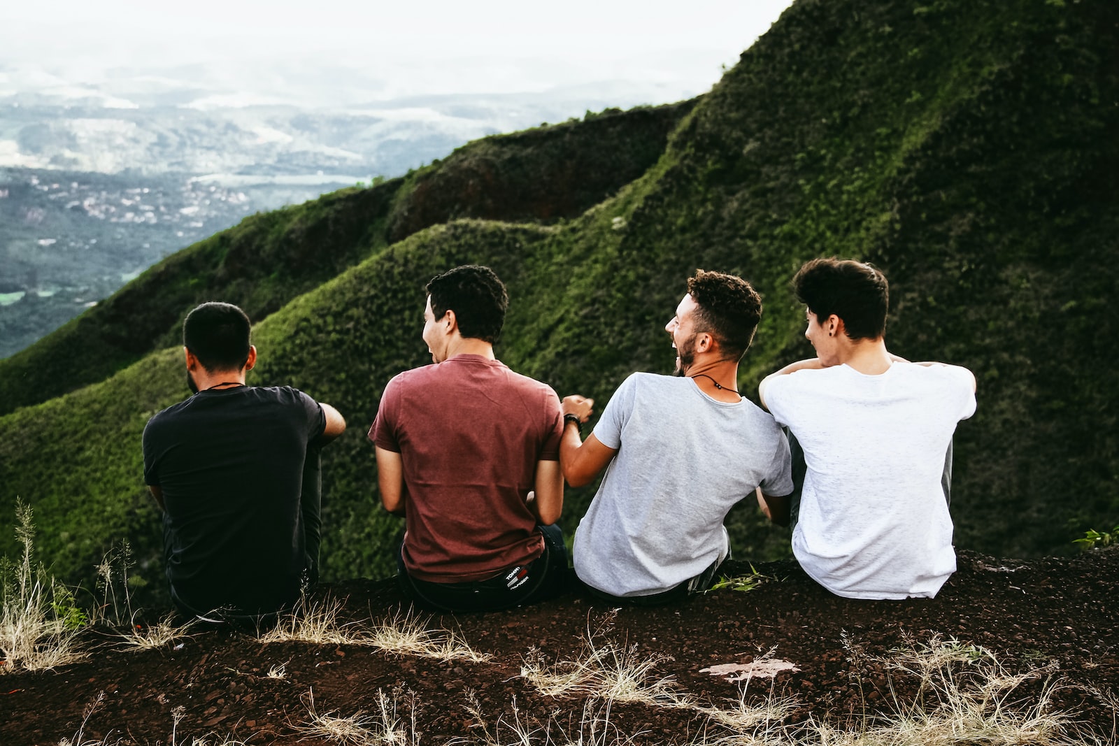 People sitting on a hill laughing