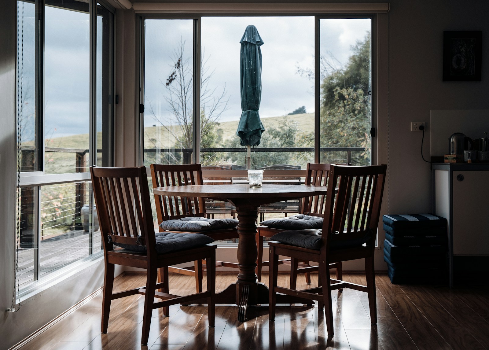 a dining room table with chairs and an umbrella