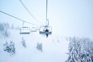 Person on a ski lift in a wintery landscape