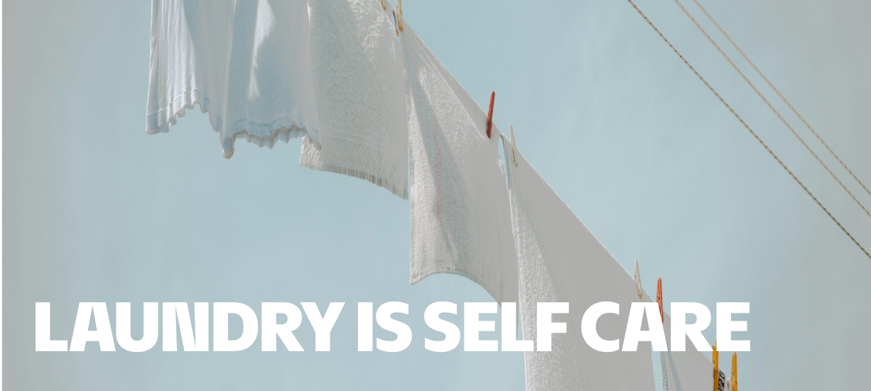Clothesline with "laundry is self-care" written on it