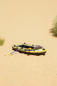 a rubber boat in the middle of the desert