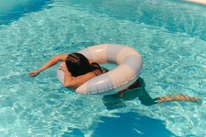 Woman floating in pool on vacation