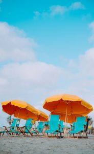 yellow parasols with turquoise deck chairs on a beach